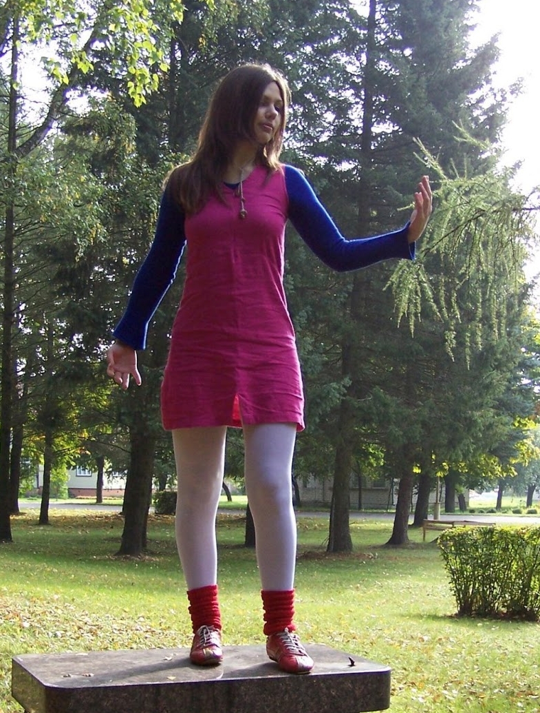 Auburn Girl wearing Red Leg Warmers on White Opaque Pantyhose